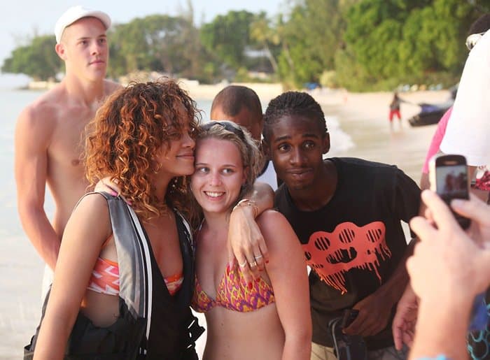 Rihanna posing with fans while on vacation in Barbados