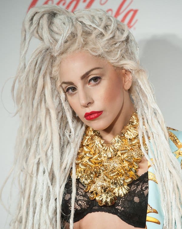 Lady Gaga with bleached dreads in a gold gold seastar print suit