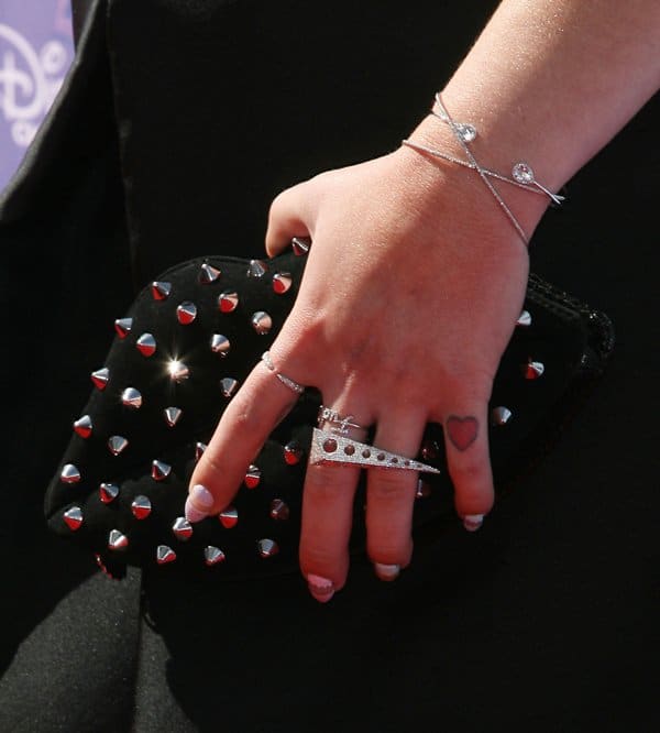 Kelly Osbourne carrying a studded clutch