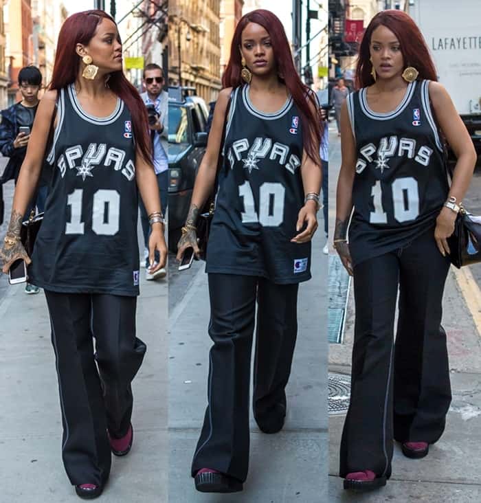 Rihanna wears black wide-leg pants from Céline‘s Spring/Summer 2015 collection and a vintage San Antonio Spurs jersey made by Champion
