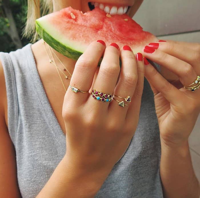 Model showing off her jewelry while eating watermelon