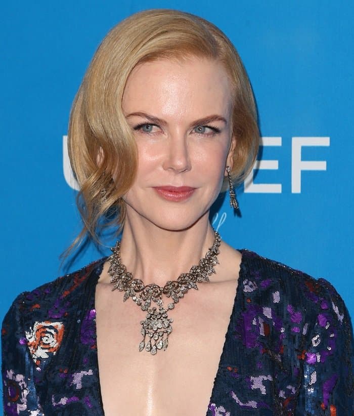 Nicole Kidman wears a sequin-embellished long-sleeve dress featuring a plunging neckline