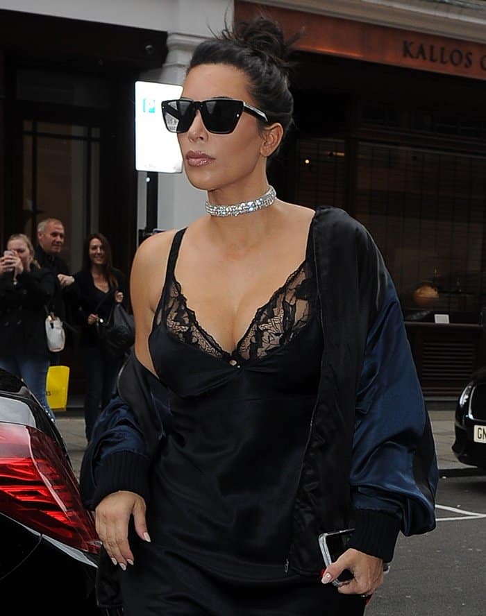 Kim Kardashian displays her cleavage and diamond choker necklace that she requested from Kanye West as a push present