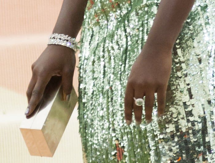 Lupita Nyong'o styled her Calvin Klein jade sequined dress with a box clutch and statement jewelry