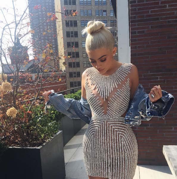 Kylie Jenner showing off her bedazzled sheer dress and her huge promise ring during New York fashion week, posted on September 12, 2016