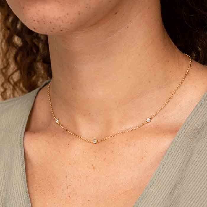The Satellite necklace offers understated elegance in 18k gold-plated silver with white sapphires